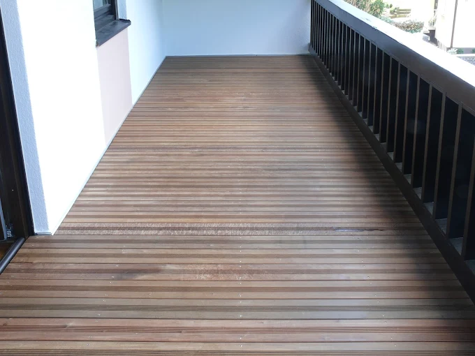 Ein schöner brauner Holzboden wurde flächendeckend auf der Terrasse verlegt.